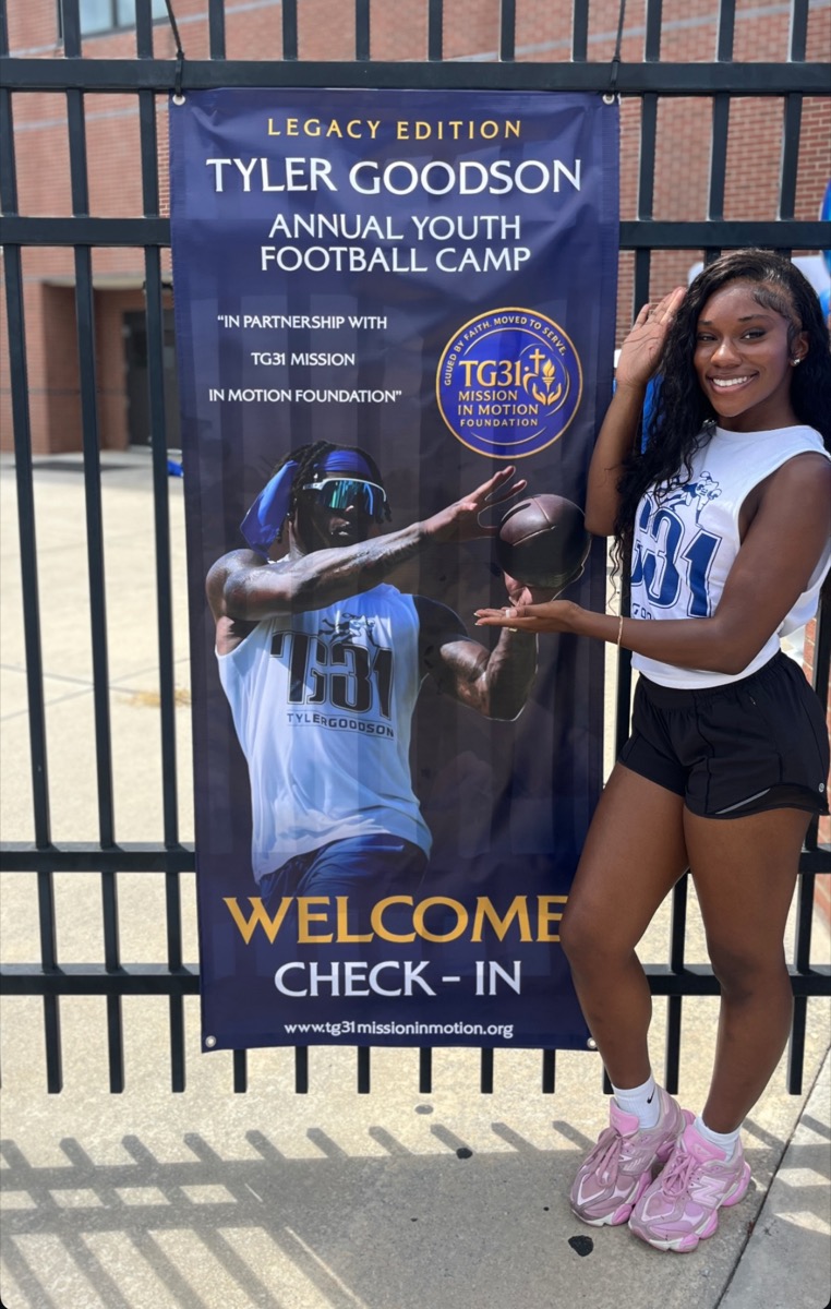 Volunteer at the TG31 Welcome Check-In banner