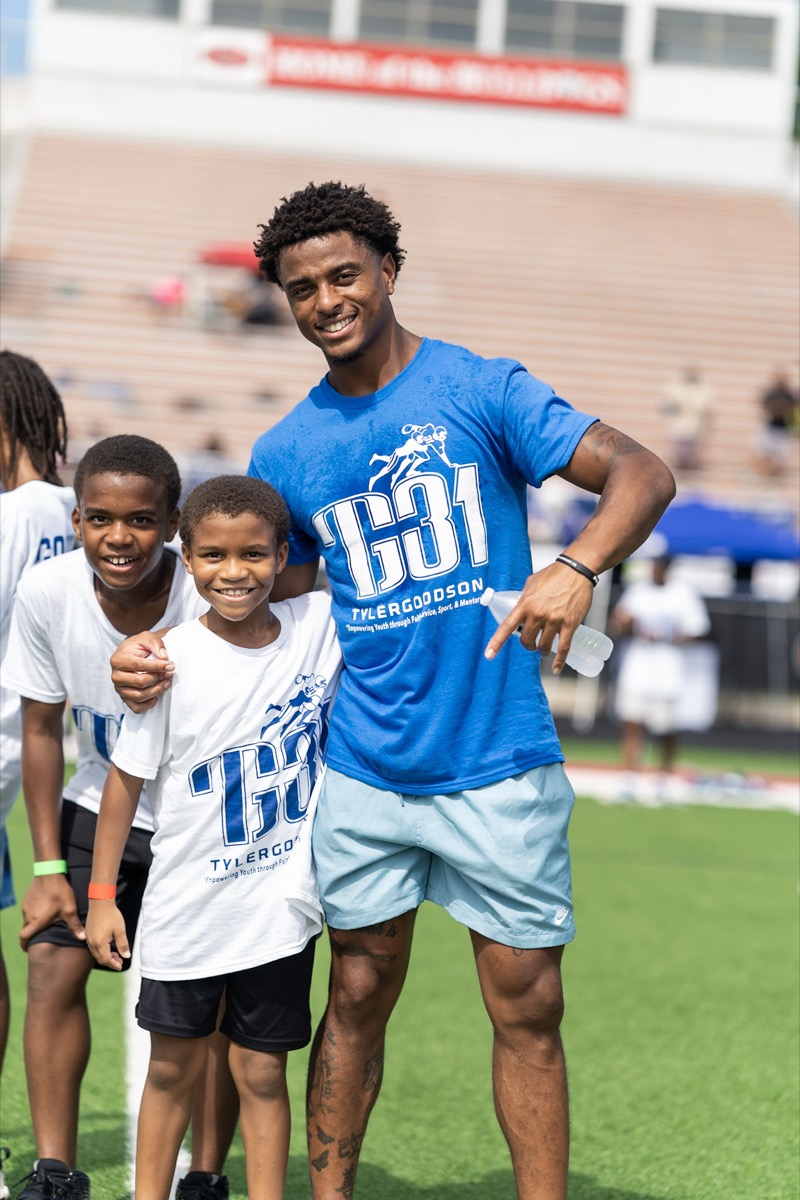 Tyler Goodson with young campers at TG31 Youth Football Camp